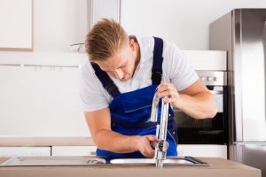 Plumber fixing a faucet