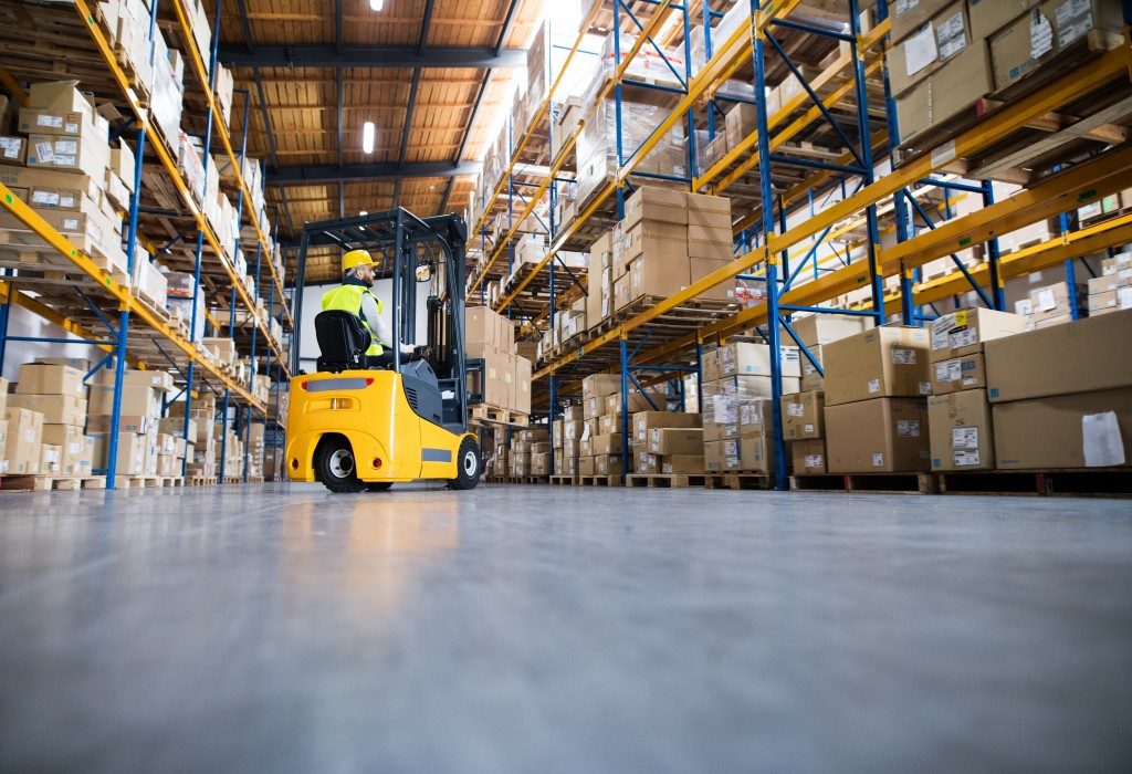 spacious warehouse with a forklift operating