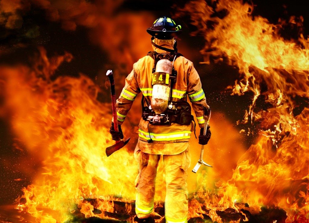 fireman in front of a raging fire