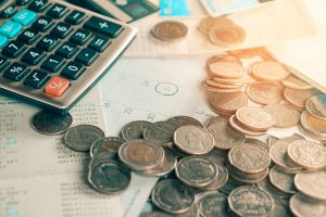 Calculator, coins and bills