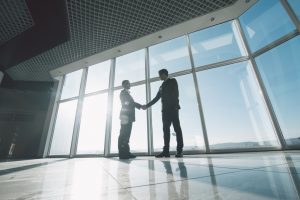 Businessmen shaking hands in a building