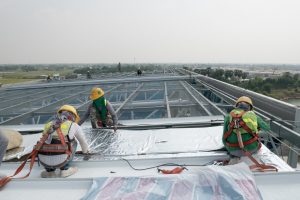 construction workers installing roof