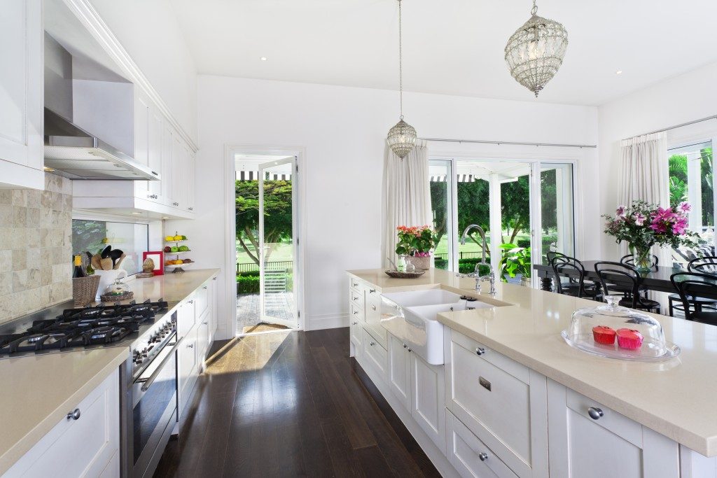stylish white kitchen with cream countertops