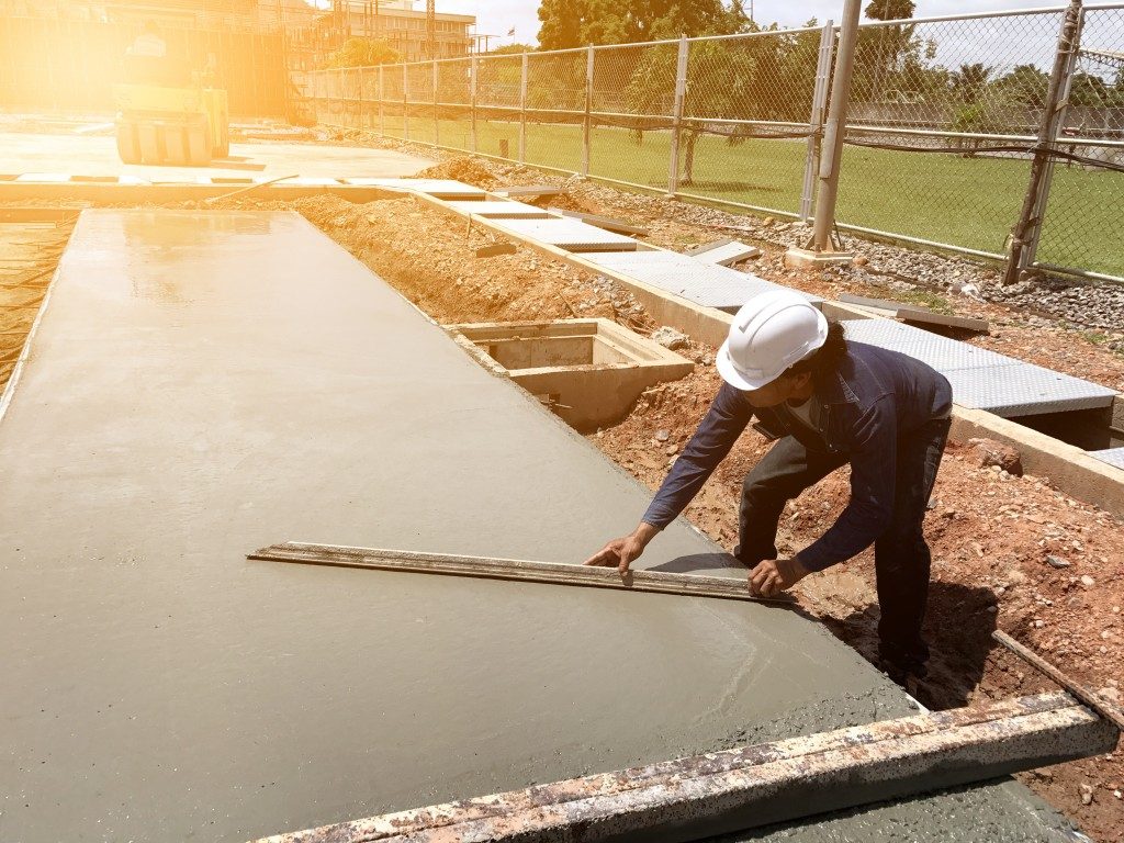Man smoothing out a layer of concrete