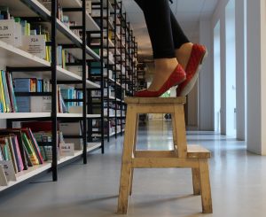 woman-stepping-on-wooden-stepping-stool