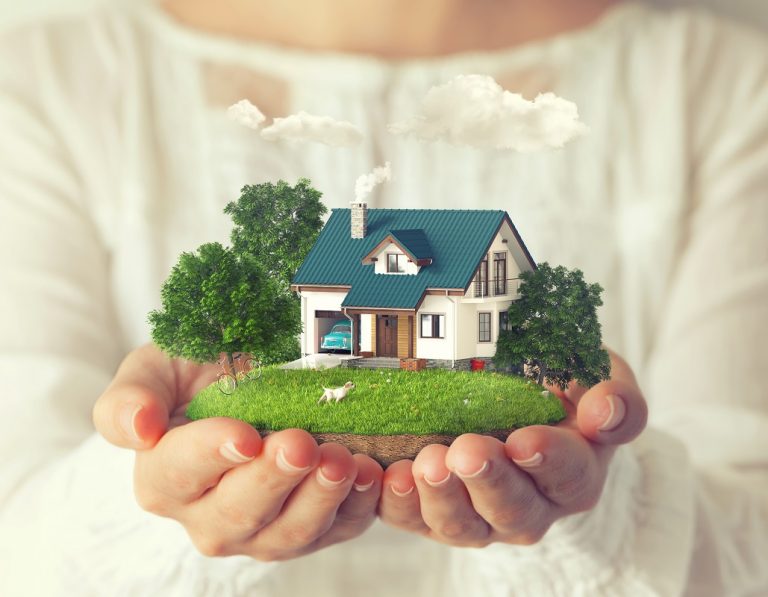 small fantastic island with a house on woman's hands